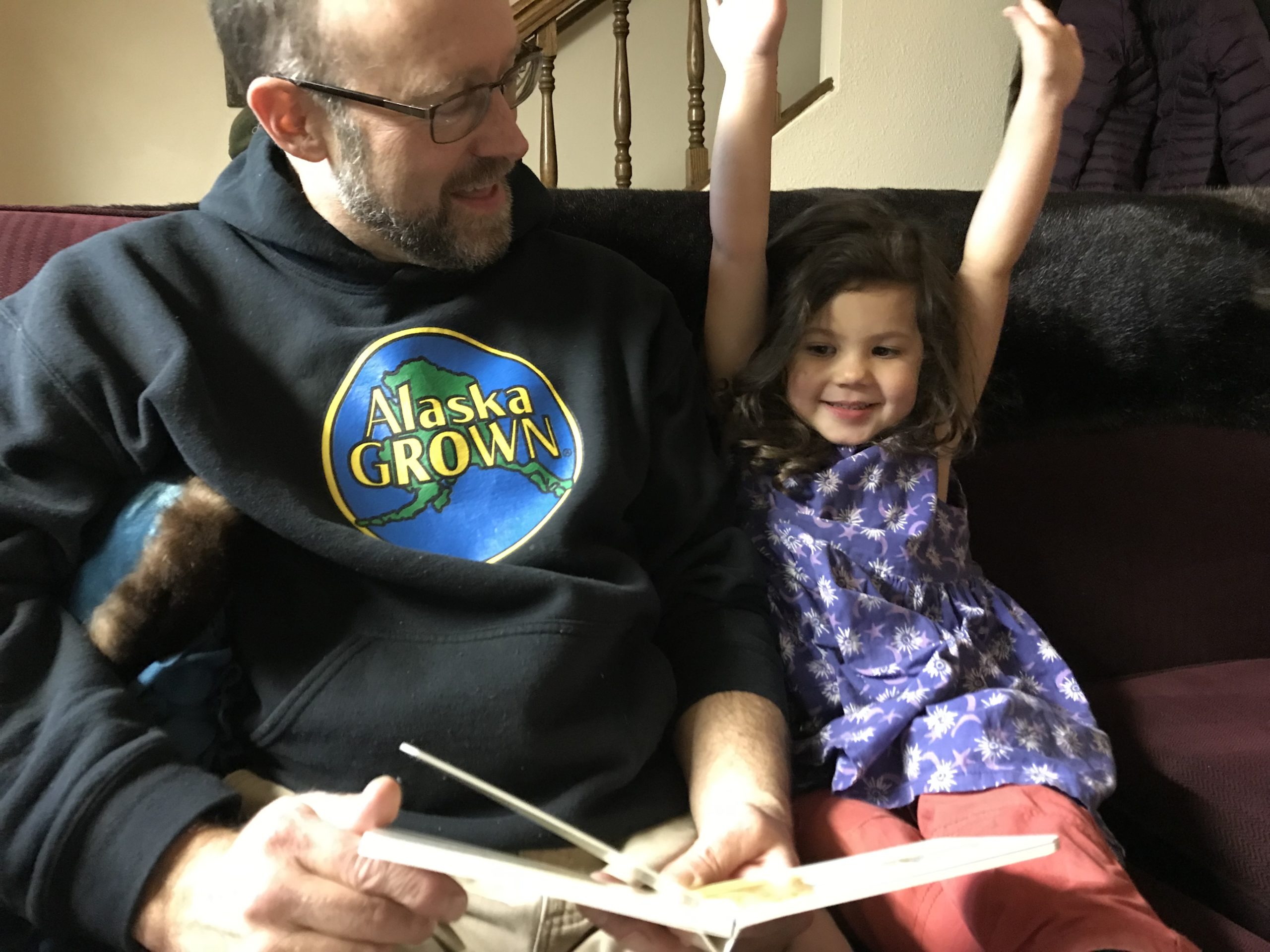 An adult reads to a child