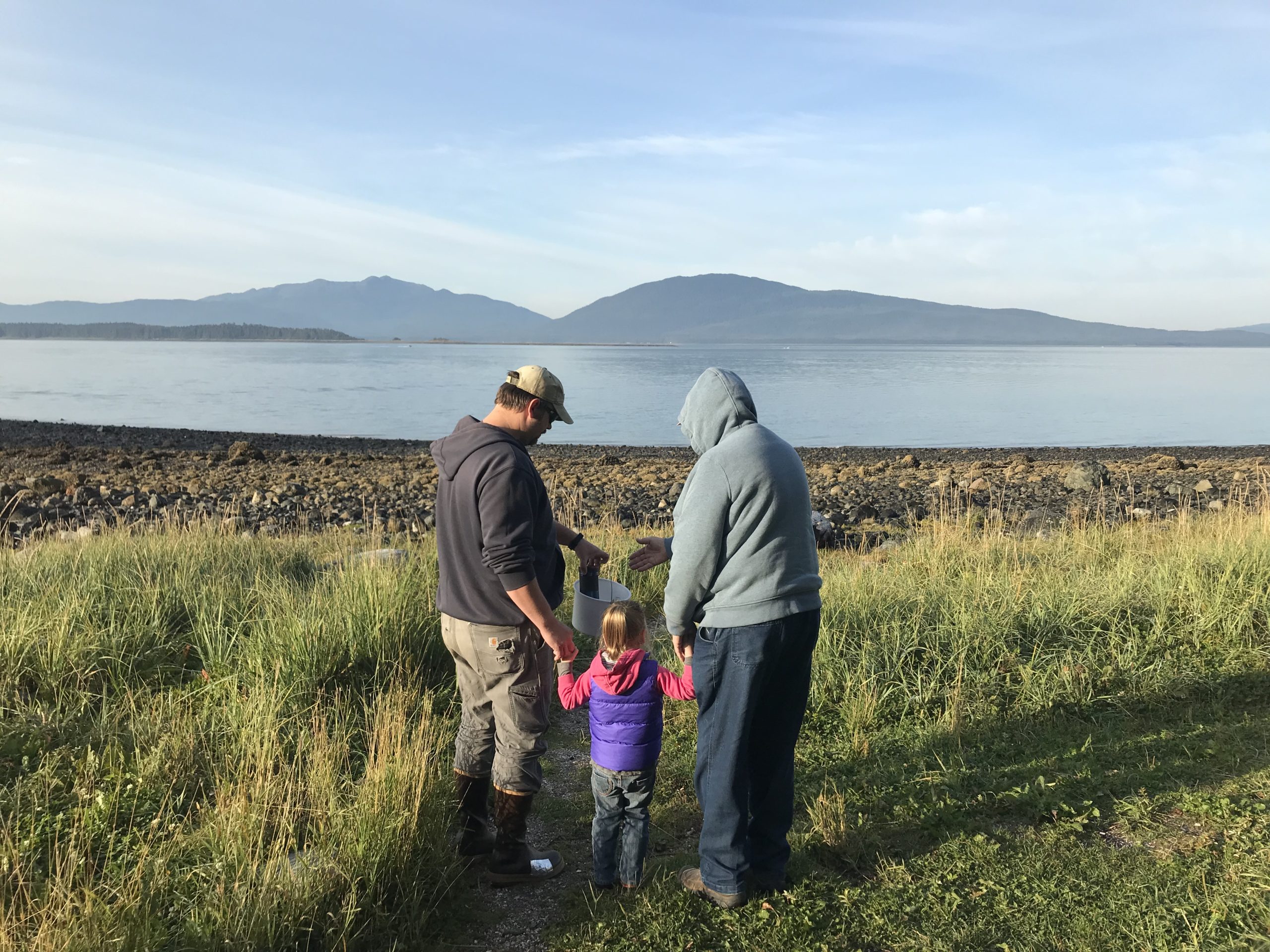 A family with a young child looks at a scenic vista